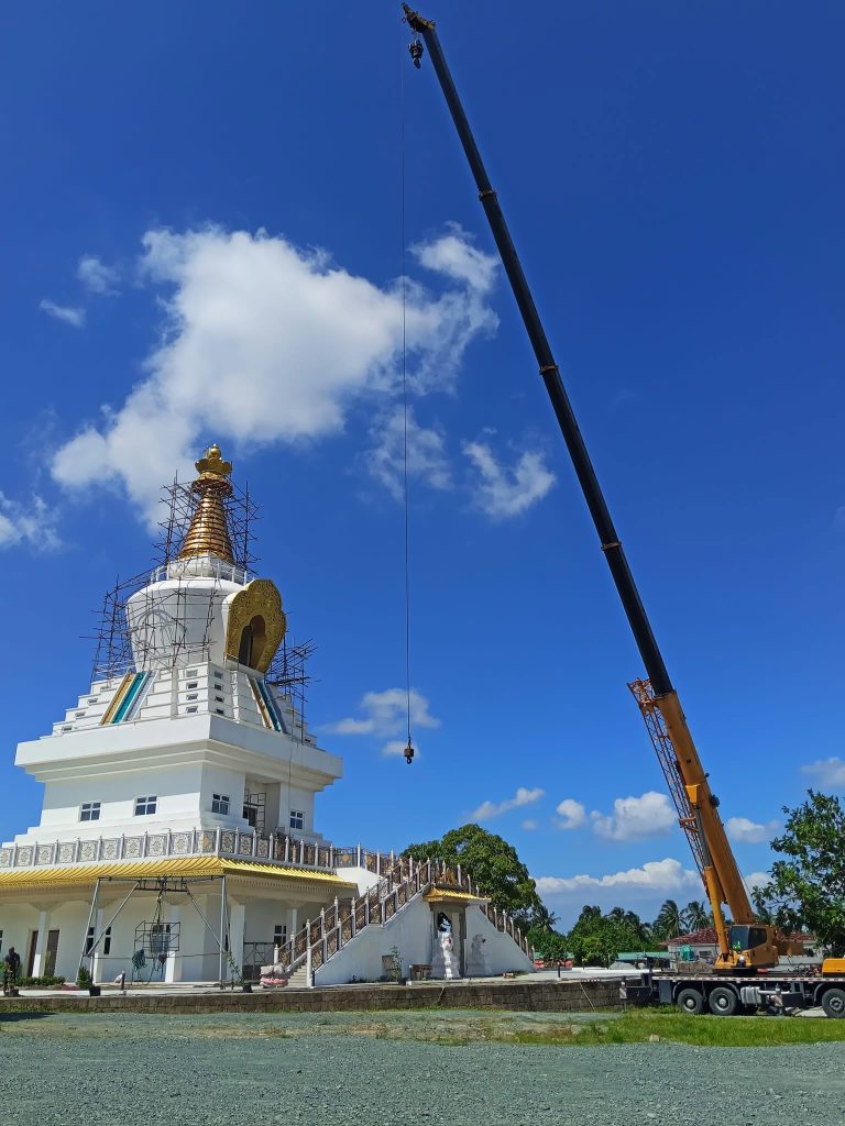 Mobile crane at a Buddhist temple for holy statue lifting in Trece Martires, Cavite, October 2026